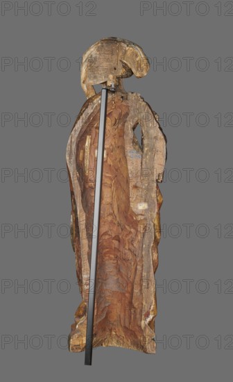 Figure of St. Mary Magdalene, ca. 1480, Southern Germany. Hollow wall sculpture, height 115.0 cm, width 35.8 cm, depth 16.2 cm. St. Mary Magdalene depicted frontally, standing in slight contrapposto with head slightly tilted left. She holds a perfume box in her left hand and its lid in her right. The face has small delicate features and a high forehead, framed by a thick braid woven with a ribbon; a white shawl draped over her head falls to the left, covers the breast and is draped over the right shoulder. She wears a double gown: an over-dress of patterned golden fabric, short-sleeved, tied at the waist creating shallow radiating pleats; the under-dress originally dark red, now darkened is visible in the significantly flared sleeves. A cloak is draped over her left shoulder, its pleated tail draped over the front and held by the left hand, showing a green lining where folded back; on the right it forms deep, rather stiffly modeled semicircular and V-shaped folds. The tip of a shoe is ...