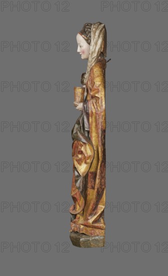 Figure of St. Mary Magdalene, ca. 1480, Southern Germany. Hollow wall sculpture, height 115.0 cm, width 35.8 cm, depth 16.2 cm. St. Mary Magdalene is depicted frontally in a slight contrapposto with her head tilted left; in her left hand she holds a perfume box and in her right its lid. The figure’s movements and hand gestures are elegant. The face has small, delicate features and a high forehead, framed by a thick braid woven with a ribbon; a white shawl draped over her head falls to the left, covers the breast and is draped over the right shoulder. She wears a double gown: an over-dress of patterned golden fabric, short-sleeved and tied at the waist creating shallow radiating pleats, and an under-dress originally dark red, now darkened visible in the flared sleeves. A cloak is draped over the left shoulder, its pleated tail draped over the front and held by the left hand, revealing a green lining where folded back; on the right the cloak forms deep, rather stiffly modeled folds with ...