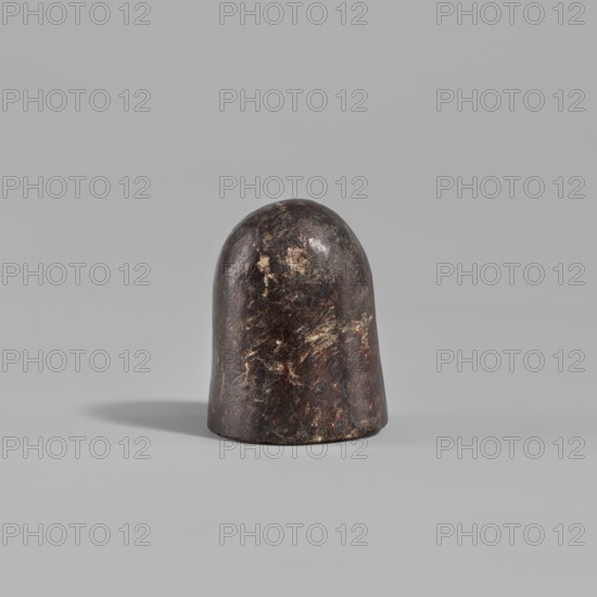 Grinder, Grinder in the shape of a rounded cylinder with a flat base, 2nd century, from Edfu, tool, height 2.8 cm, A rounded, dome-shaped object with a smooth, slightly irregular surface sits on a flat surface; the object shows a dark brown to nearly black base color with lighter brown, tan, and muted reddish patches and streaks across its surface, and it casts a soft shadow to one side against a uniform light gray background.