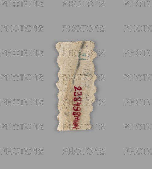 Blade — insert for a sickle;, Flint tool used as a sickle insert. Sumer, Southern Mesopotamia; Uruk culture, ca. 4th–3rd millennium BC ca. 4000–3100 BC. Tool., A roughly rectangular fragment with scalloped vertical edges sits against a flat gray background; the fragment is an off-white, beige color with darker speckles and faint grayish streaks, and there is a vertical streak of darker gray running near its center; a small area of muted green appears near the top, and there is a vertical band of bold red marks along the lower portion; the fragment's surface looks slightly rough and weathered with uneven contours.
