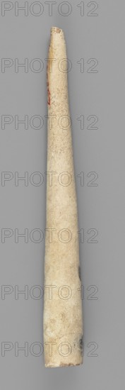 Mosaic cone; unknown creator; ; decorative elements; Sumer; Near Eastern architecture; Eastern Gallic Scenography; 4th millennium BC; Uruk culture; Sumer type of site/place of origin; Southern Mesopotamia type of site/place of discovery; element of architectural decoration., A long tapered cylindrical object placed vertically against a flat background, appearing to be made of a light beige material with a slightly rough, porous surface texture; the object shows subtle variations in beige and cream tones with a few areas of darker brownish and grayish discoloration and a small patch of faint red on one side; the background is a uniform medium gray.