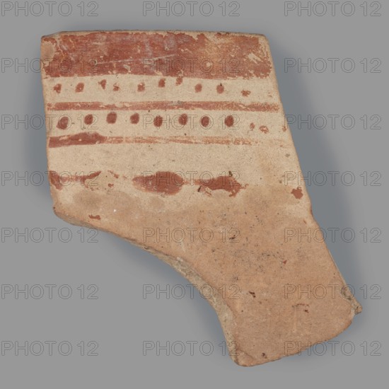Fragment of a bowl, unknown Northern Mesopotamian workshop, checkerboards, geometric motifs, painted pottery, bowls, Near Eastern pottery, Eastern Gaulish Scenery. Fragment of a bowl wall with a preserved thin rim. Before firing, the decoration, consisting of geometric motifs, was painted with ferrous clay on both sides of the bowl, over a layer of dried, heavily smoothed glaze. After firing, the painted motifs are red, while the background is cream on the outside and light brown on the inside. The outer decoration is a banded composition composed from top to bottom of a wide horizontal band, below which are alternating rows of single dots and two continuous, thin lines. Below this, a single thin line with superimposed irregular ovals remains. On the inner side, the entire surface is covered with a fine red checkered motif. c. 6500–c. 5500 BC; Halaf culture c. 5200–c. 4500 BC earlier dating, Northern Mesopotamia Iraq, Syria, Turkey. Pottery fragment; height 4.7 cm, width 4.6 cm, depth ...