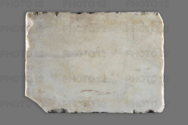 Tombstone with Latin Christian inscription, unknown Roman workshop, 4th–5th century, Roman Empire 27 BC–476, slab, height 26 cm, width 19 cm, depth 2 cm, weight 2.65 kg, A rectangular slab with slightly irregular, worn edges rests on a flat background; the slab surface is mostly light, with shades of off-white, pale gray, and creamy beige, and it shows subtle mottling and faint darker smudges and stains in brownish and gray tones, while the background is a uniform medium gray.