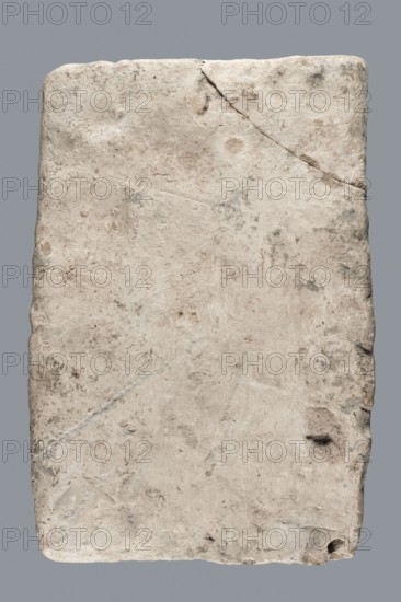 Greek inscription of thanksgiving, tombstone inscription, 30.12.23 BC, Egypt, Greek inscription, height 24.0 cm, width 14.0 cm, depth 5.8 cm, A roughly rectangular slab with uneven, worn edges and a textured surface showing pitting, chips, and hairline cracks; the slab is primarily off-white and beige with areas of light gray and faint darker gray spots and smudges, and there are subtle variations of tan and cream across the surface.