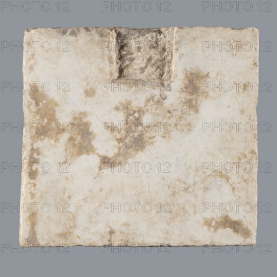 Latin grave inscription, 2nd century, Roman Empire 27 BC–476, slab, epitaph, grave inscription, height 31 cm, width 28 cm, A square, flat slab with a rough, slightly uneven edge, showing a weathered surface in shades of off-white, cream, beige, and light brown, with patches of darker brown discoloration and mottled staining; near the top center there is a shallow, rectangular recess with a rough, textured bottom that appears darker and more shadowed, and the slab sits against a smooth mid-gray background.
