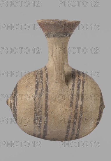 Cypriot gourd jug, Excavated at Nea Paphos Cyprus. Cypriot pottery, Cypriot Bichrome Ware III. Small vessel with a barrel-shaped gourd-shaped body, without a foot, with a spherical bottom. On both shorter sides the center is marked with a small protruding point. A single ring-shaped handle on the longer side, mounted above half the height of the body and at the base of the neck, curving downwards. Quite long neck, strongly flaring, conical spout. Yellow clay with yellow-brownish engobe. Decoration in black-brown and matte red: the spout is decorated externally with a wide matte red band beneath a narrower black band; the belly is decorated on both sides with two groups of three concentric black-and-brown lines of varying widths and spacing; in the groups on the shorter sides the outer line is much wider than the others. Protruding points are marked in black-and-brown. Dated 850–700 BC. Vessel from Cyprus., A rounded vessel with a narrow neck and flared rim sits against a plain backgrou...