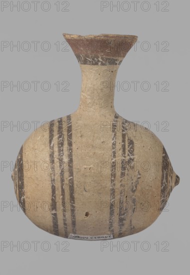 Cypriot gourd jug, Excavated at Nea Paphos Cyprus. Cypriot pottery, Cypriot Bichrome Ware III. Small vessel with a barrel-shaped gourd-shaped body, without a foot, with a spherical bottom. On both shorter sides the center is marked with a small protruding point. A single ring-shaped handle on the longer side, mounted above half the height of the body and at the base of the neck, curving downwards. Quite long neck, strongly flaring, conical spout. Yellow clay with yellow-brownish engobe. Decoration in black-brown and matte red: the spout is decorated externally with a wide matte red band beneath a narrower black band; the belly is decorated on both sides with two groups of three concentric black-and-brown lines of varying widths and spacing, the outer line in the groups on the shorter sides being much wider than the others. Protruding points are marked in black-and-brown. Date: 850–700 BC. Place of origin: Cyprus. Type: vessel., The image shows a rounded ceramic vessel with a narrow nec...