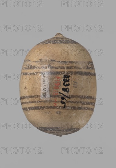 Cypriot gourd jug, Excavations at Nea Paphos Cyprus — Cypriot pottery, Cypriot Bichrome Ware III. Small vessel with a barrel-shaped gourd-shaped body, without a foot, with a spherical bottom. On both shorter sides the center is marked with a small protruding point. A single ring-shaped handle on the longer side, mounted above half the height of the body and at the base of the neck, curved downwards. Quite long neck, strongly flaring, conical spout. Yellow clay with yellow-brownish engobe. Decoration in black-brown and matte red: the spout externally has a wide matte red band beneath a narrower black band; the belly on both sides has two groups of three concentric black-and-brown lines of varying widths and spacing, with the outer line much wider in the groups on the shorter sides. Protruding points are marked in black-and-brown. Dated 850–700 BC, Cyprus, vessel., A roughly egg-shaped object with a pointed top and a rounded bottom sits against a plain light gray background; the object h...