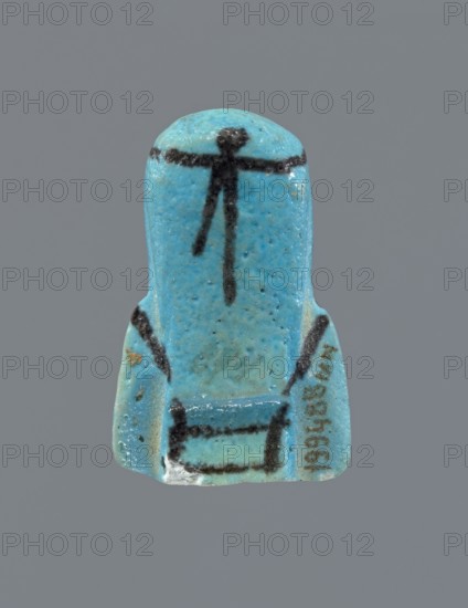 Ushabti, Mummy-shaped figurine, preserved head and fragment of torso. Arms crossed on the chest, hands at the same level, next to each other, holding hoes in each hand. On the back a rectangular basket is slung on strings over both shoulders. On the head is a long, smooth, three-part wig with a headband. Triangular face with proportional details; eyes slightly closed. Headband, tools, and facial details painted. ca. 945–ca. 715 BC; Third Intermediate Period, 22nd–23rd Dynasty, Egypt. Ushabti, height 5.2 cm., A small turquoise-blue figurine-shaped object with a smooth rounded top and flared base, showing a few dark black linear markings on the front including a horizontal line near the top and several vertical and diagonal strokes down the center and sides; the surface shows variations of lighter and darker turquoise with some speckling and tiny pits, a small area of white abrasion at the lower edge, and a faint patch of brown discoloration on one side, all set against a plain gray back...