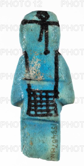 Shabti with baskets on the back, Mummy-shaped funerary figurine, preserved fragment from the knees up. Arms crossed on the chest, hands placed at the same level, next to each other, holding hoes in each hand. On the back, a rectangular basket slung on strings over both shoulders. Wears a long, smooth, three-part wig with a headband. Triangular face, proportional details, eyes slightly closed. Painted facial details. Painted inscription placed in a column separated by vertical lines on the front of the legs, starting just below the folded hands; text includes ...of the soul belonging to Osiris.... Third Intermediate Period, ca. 1069–715 BC 21st–23rd Dynasty, Egypt. Shabti; height 7.6 cm, width 3.2 cm., A small turquoise-blue figurine shaped like a stylized human form with a rounded head, narrow shoulders, and an elongated body, showing a textured surface and areas of lighter and darker blue; several black painted lines and patterns appear on the head, torso, and lower body including a h...