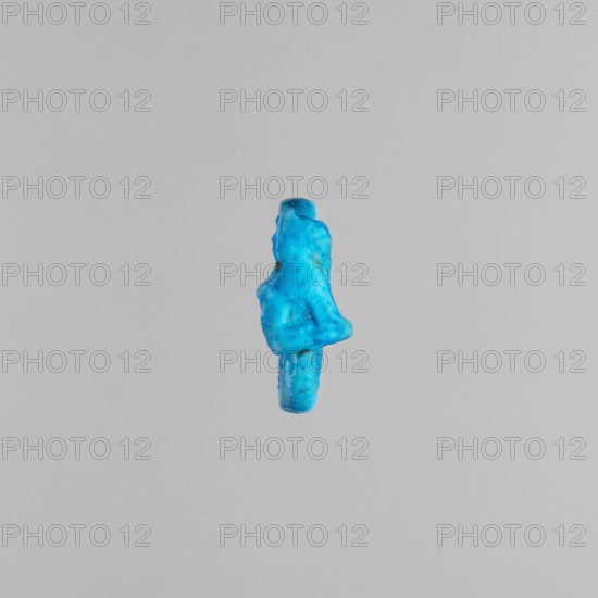Ring with a kitten;, sacred animal subject; ca. 1550–1295 BC, New Kingdom, 18th Dynasty, Egypt; ring/amulet; height 1.8 cm., A small irregularly shaped object in bright blue with variations of lighter and darker blue tones and small speckles of a slightly different hue, floating against a uniform light gray background; the object has a textured, uneven surface with rounded protrusions and indented areas, appearing elongated with a thicker upper portion and a narrower lower portion.