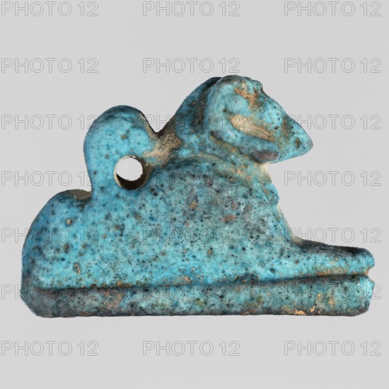 Amulet — ram. Figurine of a ram lying on a flat base, with a loop for hanging on its back. Material: amulet. Subject: sacred animal ram, pendant. Date: 664–332 BC, Late Period, Egypt. Dimensions: height 2.9 cm, width 1.9 cm. Creator: unknown., A small object shaped like a reclining animal with a rounded head and raised snout, shown against a plain light gray background, colored predominantly turquoise with areas of darker blue speckling and patches of brownish-gold wear; the surface shows a rough, pitted texture and a small circular hole near the upper back area, and the base appears darker with a thin layered edge.
