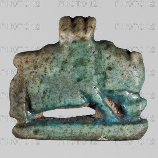 Amulet — hippopotamus; creator, purchase provenance; hippos; protective amulets; pendants; 664–332 BC, Late Period, Egypt; amulet; height 1.5 cm; width 2 cm, An irregularly shaped small object with a rough, weathered surface in shades of turquoise, teal, green, pale blue, brown, and beige; the piece shows a horizontal base with a narrow open slit above it and an upper section that rises into a rounded, slightly scalloped protrusion; the surface has mottled speckles of darker brown and green, areas of smoother glossy turquoise, and patches where the underlying beige material is exposed, with subtle shadows and highlights emphasizing the textured, pitted surface.