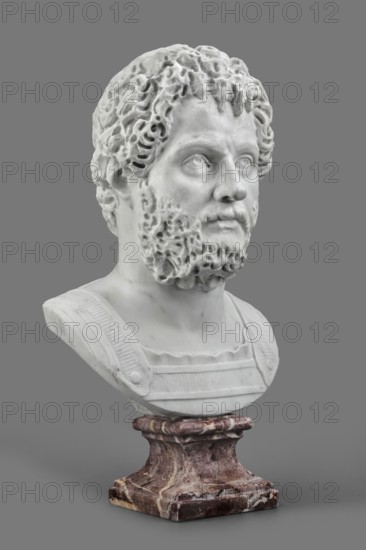 Portrait of Emperor Septimius Severus, unknown Roman workshop; Roman Empire 27 BC–476; sculpture; height 56 cm, width 30 cm, depth 24.5 cm; dated 193–211., A white marble bust of a bearded man with curly hair is shown against a solid gray background, mounted on a mottled brown and cream marble pedestal; the bust displays detailed facial features and textured hair and beard, and the clothing suggests a sculpted chest plate with straps, all rendered in shades of white and light gray contrasted with the pedestal’s brown, cream, and reddish tones and the surrounding gray.