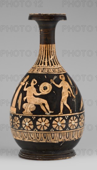 Red-figure bottle with a scene of the punishment of Marsyas, red-figure Greek pottery, 330–310 BC. Vessel glued from several fragments; minor additions on the neck, flaking of white and yellow retouches covering the silhouette of Silenus. Between the ornamental bands covering the lower half of the neck and belly, a scene depicts the punishment of Marsyas. Marsyas sits on the field of a cloak, the other end covering his right thigh; the lower part of his torso faces left while the upper part, with his hands tied to a tree in front, faces right toward Apollo standing next to him. Apollo stands beside a table on a platform, holding a lyre placed on it and a taenia in his right hand, which flutters above Silenus’s head. A Scythian stands before Marsyas, holding a knife in his right hand and beginning to flay him. The scene includes three satyrs and a column with an oval object omphalos?. The depiction reflects the mythic musical contest agon between Apollo lyre and Marsyas aulos. Bottle ve...
