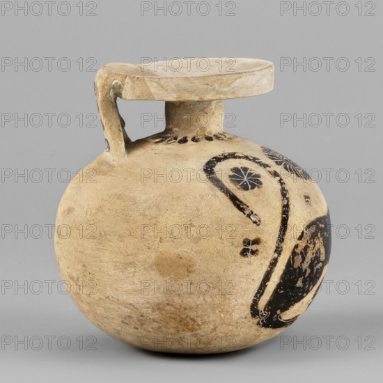 Aryballos with a depiction of a panther, Seated Panther Painter c. 620–590 BC. Spherical aryballos with a low cylindrical neck and squat belly. Image of a seated panther facing right with a long curled tail. Visible red retouching; details highlighted with engraved lines. One rosette of the filling ornament is unfinished. Small amount of filling ornaments rosettes. Small rays near the neck. Four lines on the vase. Remnants of a ray ornament at the bottom. Technology: Smooth surface. Good-quality glossy varnish. Notes: Reconstructed rim. Visible chips, cracks, and impurities. Clay color: 2.5 YR 8/3 pale yellow. Black color: 5 YR 2.5/1 black. Red color: 7.5 R 4/2 weak red. Attributed place of origin: Corinth. Type: aryballos vessel. Date: 620–590 BC. Dimensions: height 6.9 cm; width 6.6 cm; rim diameter 3.7 cm; weight 0.066 kg., The image shows a round, bulbous ceramic vessel with a short neck and a flat, slightly concave rim connected to the body by a single looped handle; the surface i...