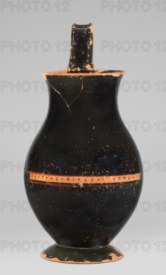 Olpe type of jug for liquids with inscription, unknown Attic workshop; Crito ca. 550–500 BC signature KRITONEPOIESEN: Krito made it, Greek ceramics, pottery marks, Greek inscriptions. Black-finished olpe with a clay-coloured cartouche at the point of maximum diameter. Medium-sized olpe; rim edge slightly turned outwards; low neck gently transitioning into a concave, spherical belly clearly distinguishable from the low conical foot with a recess; bottom slightly convex; profiled handle with clearly distinguishable edges. On the inner side of the rim two clay nodules one reconstructed are visible, located 4.5 cm apart on the handle side. Date: 550–500 BC. Place of origin: Attica, Athens. Object type: olpe vessel. Dimensions: height 26 cm, width 13.5 cm, depth 15.5 cm, weight 0.58 kg., A tall pottery vessel with a narrow neck and single strap handle rising from the rim, showing worn areas and chips that reveal a reddish-brown clay beneath a glossy black surface; the body is bulbous with a...