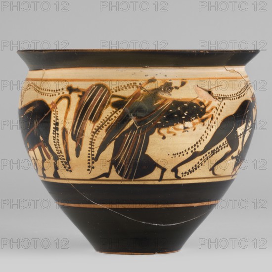 Black-figure skyphos with depictions of Athena and Heracles fighting the Cretan Bull, early 5th century BC, Attica. Thin-walled skyphos with a wide rim flaring outward, deep bowl convex in the upper part tapering towards a small-diameter, slightly concave base. Interior: reserved edge 1–2 mm with an uneven strip around the vessel; interior surface covered with black varnish except for the reserved edge. Decoration: Heracles taming the Cretan bull; figures include Athena and Heracles. Technology: cleaned, homogeneous clay, uniformly fired, high-quality matte varnish applied in an even layer but unevenly fired visible greenish tint on the rim; traces of turning visible under the varnish; surface smooth with admixtures mica? visible on the interior varnish. Condition: secondary losses on the surface, visible remains of conservation treatments; glued. Attributed/described by Kamila Nocon. Type: skyphos vessel. Dimensions: height 8.6 cm, width 10.2 cm, weight 0.15 kg., A rounded ceramic ves...