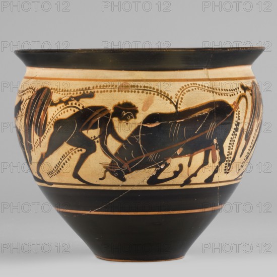 Black-figure skyphos with depictions of Athena and Heracles fighting the Cretan Bull, Heracles mythology; Athena mythology; bulls; Greek ceramics; Greek deities. Physical description: Thin-walled skyphos with wide rim flaring outward, deep bowl convex in the upper part tapering towards a small-diameter slightly concave base. Interior: reserved area 1–2 mm on the edge with a strip of uneven width; interior surface largely covered with black varnish except for the edges, which have an uneven layer. Scene: Heracles taming the Cretan bull. Technology: cleaned, homogeneous clay, uniformly fired; high-quality matte varnish applied in an even layer but unevenly fired visible greenish tint on the rim. Traces of turning visible under the varnish; surface smooth; admixtures mica? visible on the interior varnish. Notes: secondary losses visible; remains of conservation treatments; glued artifact. Attributed to Kamila Nocon; early 5th century BC; Attica; type: skyphos vessel. Dimensions: height 8....