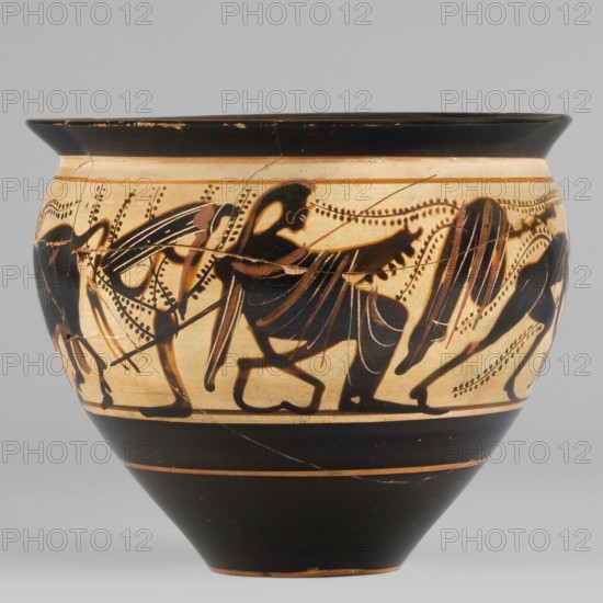 Black-figure skyphos with depictions of Athena and Heracles fighting the Cretan Bull, Early 5th century BC, Attica. Skyphos vessel. Subject: Heracles taming the Cretan bull; Athena present. Technology/materials: Cleaned, homogeneous clay, uniformly fired, high-quality matte varnish applied in an even layer unevenly fired with a greenish tint on the rim; traces of turning visible under the varnish; surface smooth; possible mica admixtures visible on the interior varnish. Technique: black-figure decoration. Physical description: Thin-walled skyphos with wide rim flaring outward, deep bowl convex in the upper part tapering to a small-diameter slightly concave base. Interior: reserved edge zone 1–2 mm with a surrounding strip; interior surface largely covered with black varnish, edges with uneven varnish. Condition: secondary losses on surface, visible remains of conservation treatments, glued artifact. Dimensions: height 8.6 cm, width 10.2 cm, weight 0.15 kg. Attributed/recorded by: Kamil...