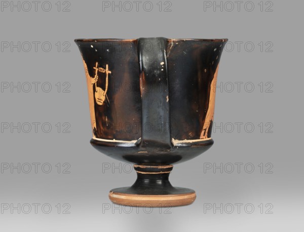 Red-figure kantharos with a depiction of an ephebe with an aryballos and a Greek inscription “Beautiful boy”;, Kantharos with a slightly flared spout, a deep bowl, a flat bottom, a high profiled stem, a ring-shaped foot. Thin-walled. A: bearded man with a lyre in his head in left profile, holding a lyre in his left hand. B: ephebe with aryballos. The inner surface of the bowl is covered with varnish. Technology: Smooth surface. The varnish is thick, shiny, unevenly fired. Notes: the vessel is intact; small secondary losses and chips are visible on the surface. Varnish color: 10 YR 2/1 Black. Date: ca. 450 BC mid-5th century BC. Place of origin: Attica. Type: kantharos, vessel. Dimensions: height 11 cm, width 16.2 cm, depth 10.2 cm., A single ceramic vessel with a broad rim, a central vertical handle, and a footed base sits against a plain background; the vessel shows a glossy black surface with areas of orange showing through where the black glaze is worn or intentionally left, includi...