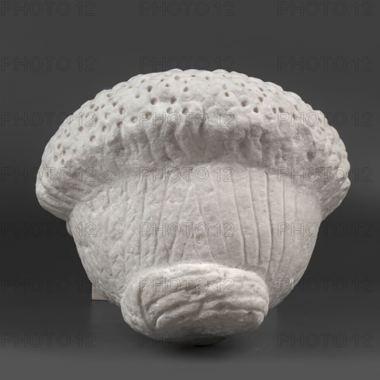 Portrait of a Roman woman, Head with a broad face and an elaborate hairstyle: hair twisted into small curls marked with a gimlet; the rest gathered at the back in a small bun. Round, full face, with a triangular forehead. Female portrait, Roman sculpture, hairstyles, masterpiece. Date: 82–92 CE, Rome, — Roman Empire 27 BC–476. Sculpture; height 30.5 cm, width 27 cm, depth 25 cm, weight 36.5 kg., A textured three-dimensional object with a rounded top and a narrower base, displayed against a dark gray background; the object appears to be pale white with subtle off-white shading, featuring a bumpy, pocked upper surface, vertical ridges along the lower portion, and a rolled, folded detail at the bottom, all shown with soft shadows and highlights.