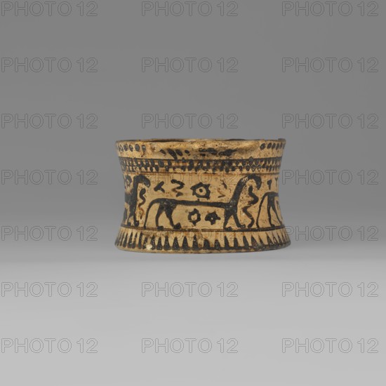 Orientalising pyxis with an animal frieze in the Silhouette style, images of animals, Middle Corinthian period 590–570 BC, cats. Thin-walled pyxis with a straight rim, slightly concave body walls, and a flat bottom. Small vices mounted horizontally just near the edge of the rim. The main decorative band, bounded at the top and bottom by a thin line of varnish, depicts figures of animals executed using the silhouette technique. Between the silhouettes there are simplified filling ornaments. Clay color: 5 Y 8/2 pale yellow Varnish color: 5 Y 2.5/1 black Corinth, pyxis vessel. Height 5.3 cm, width 10.2 cm, depth 8.5 cm, weight 0.102 kg., A short, flared cylindrical ceramic vessel sits centered against a neutral gray background; its body is a warm tan with dark brown or black painted decorations that form bands around the top and bottom edges and a central frieze. The painted frieze shows stylized animal figures and abstract motifs rendered in the dark color, repeating around the vessel, a...