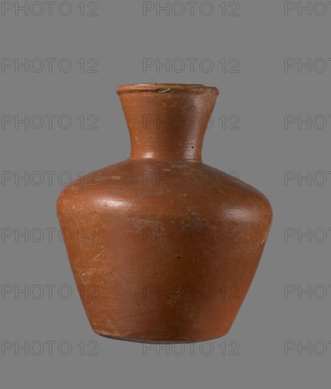 Jug, medium-sized biconical clay jug. Vessel widest at about half its height with wide shoulders and a wide, almost cylindrical neck that widens toward the spout; neck height about one-third of total. Profiled, irregular spout slightly raised and extended on one side forming a small secondary spout; spout nearly triangular in cross-section with a circa 1 mm cylindrical bulge on the outer profile. Bottom almost flat, very slightly rounded. Made of Nile clay NB1 ? — Vienna System. Neck likely made separately and joined to the shoulders. Outer surface leveled, covered with an engobe and polished; inner surface leveled except for the neck, which is also engobed and polished. Color reddish-brown. Quite well preserved; rim slightly chipped in two places and outer engobe worn in spots. Analogous to a similar jug from Edfu; dated to the 6th Dynasty Old Kingdom, ca. 2686–2181 BC. Dimensions: height 20.5 cm; rim diameter 8.5 cm; body diameter 17.3 cm; bottom diameter 10.9 cm., A single pottery v...