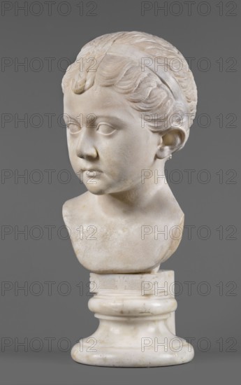 Portrait of a princess from the Julio-Claudian dynasty Julia?, unknown Roman workshop. The bust depicts a girl with a round, rather chubby face, turned slightly to the right; a rounded, elongated chin, and small, slightly pursed lips with a pronounced, wavy line of the upper lip. The almond-shaped, smooth eyes are rather shallowly set, with marked upper eyelids and barely visible eyebrows. The ears are carefully styled. The wavy hair is combed up and tied with a headband; at the back of the head it is tied in a bun with a braid that falls down the middle of the head onto the smooth forehead. End of the 1st century BC–beginning of the 1st century, Roman Empire 27 BC–476. Sculpture; height 25.7 cm, width 16 cm, depth 12.5 cm, weight 11.5 kg., The image shows a marble bust of a young person with short, wavy hair held back by a band, styled with a small curl at the forehead; the face is turned slightly to one side with a neutral expression, visible ears, and smooth cheeks. The bust include...