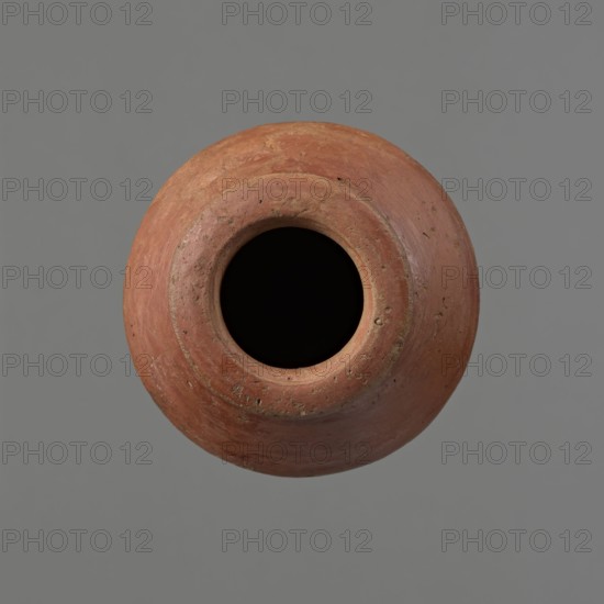 Vessel, unknown creator; Egyptian pottery, clay vessel, c. 1650–c. 1550 BC Second Intermediate Period, Edfu; vessel; height 7.4 cm, rim diameter 5.5 cm, belly diameter 8.2 cm., A round earthenware vessel viewed from above with a wide circular opening revealing a deep black interior, the vessel surface showing a rough, weathered texture in terracotta and reddish-brown tones with patches of lighter clay and small areas of dark brown and gray, set against a plain gray background.