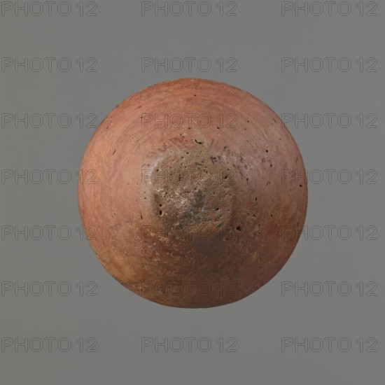 Vessel, Egyptian pottery vessel of clay, c. 1650–c. 1550 BC Second Intermediate Period, Edfu. Height 7.4 cm; rim diameter 5.5 cm; belly diameter 8.2 cm., A round, weathered object with a rough, pitted surface floating against a plain background, showing a predominately reddish-brown color with areas of muted orange, rusty brown, and small patches of darker brown and gray; the surface texture includes irregular marks, small holes, and uneven discoloration, and the background is a solid gray.