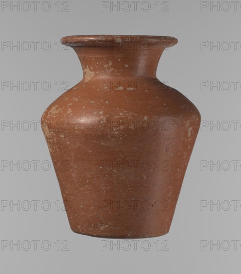 Vessel, Egyptian pottery vessel, clay; conical, widest at ~3/4 height. Shoulders wide, almost horizontal, slightly sloping. Neck wide, short, funnel-shaped, widening toward the spout. Spout wide, flat at top, slightly rounded at bottom, slightly asymmetrical. Bottom slightly convex, asymmetrical. Surface even; lower part worked to ~2/3 height with a knife or similar tool. Outer surface and inner surface of rim and neck covered with dark red engobe. Color dark red. Complete; surface eroded in many places, numerous clay chips on the rim. Attributed to ca. 2686–ca. 2181 BC Old Kingdom, from Edfu. Vessel height 16.7 cm; rim diameter 9.5 cm; body diameter 13 cm; bottom diameter 8.1 cm. References: Reisner, Mycerinus, p. 219, types XIX and XX, fig. 69., A single terracotta-colored ceramic vessel with a wide flared rim and a rounded shoulder tapering to a narrower base, showing areas of lighter wear and small surface imperfections; the background is a uniform light gray.