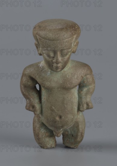 Amulet - Ptah-dwarf Pataikos, maker, subject: Ptah-dwarf mythology. Figurine of a naked dwarf man with a large head with a wide forehead, short arms with clenched fists pressed to the hips, and short legs broken off at the knees. Careful modelling. Late Period, Egypt, 7th–4th century BC. Terracotta figurine/amulet; height 6.5 cm, width 3.7 cm, depth 2.6 cm., A small sculpted figure of a childlike person standing with hands on hips, carved in a mottled greenish-brown stone or metal with areas of lighter green patina; the figure has a rounded flat top of the head, closed eyes, a small nose and mouth, rounded shoulders, a slightly protruding belly with a visible navel, short thick legs, and simple rounded feet; the surface shows weathered texture and spotting, and the background is a flat medium gray.