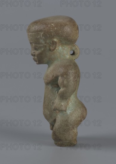 Amulet - Ptah-dwarf Pataikos, Ptah-dwarf mythology. Figurine of a naked dwarf man with a large head with a wide forehead, short arms with clenched fists pressed to the hips, and short legs broken off at the knees. Careful modelling. 7th–4th century BC; Late Period, Egypt. Figurine, amulet. Height 6.5 cm; width 3.7 cm; depth 2.6 cm., A small sculpted figure viewed in profile against a plain gray background, showing a stylized human form with a rounded head, pronounced forehead, and a short neck with a circular loop at the back. The figure has a compact torso, rounded shoulders, a slightly protruding chest, and short arms with simplified hands resting near the hips. The lower body features full hips and sturdy legs with rounded knees and feet. The surface appears weathered with mottled tones of brown and greenish-blue patina, with some areas darker brown and others showing lighter greenish corrosion. The overall texture looks rough and aged.