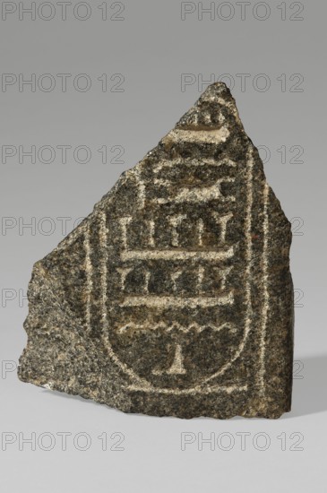 Fragment of a block with the Sheshonq cartouche; Sheshonq ruler of Egypt; ca. 945–715 BC. Cartouches are ovals of double-wound rope signifying protection; a fragment of the relief shows the cartouche of Pharaoh Sheshonq of the 22nd Dynasty. It is unknown whether this refers to the dynasty's founder the biblical Shishak or to one of four other rulers of this name. Royal cartouches and hieroglyphic texts could be written vertically or horizontally; the characters inside this cartouche point left, indicating the pharaoh's figure faced the same direction. ca. 945–ca. 735 BC; Third Intermediate Period, 22nd Dynasty, Egypt. Bas-relief; height 15.5 cm, width 13 cm, depth 6 cm, weight 1.138 kg., A rough triangular fragment of dark stone with lighter carved grooves forms a rounded rectangular motif on its face; the stone surface shows a speckled texture with visible grain and uneven edges, and the carved lines create stacked horizontal shapes and small rounded depressions within the motif, with...