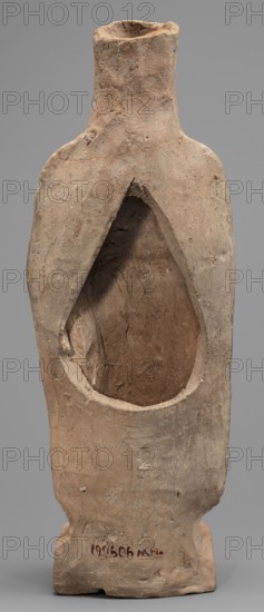 Figurine of a woman standing on a rectangular base. The woman is dressed in a finely pleated chiton reaching down to her bare feet, with a semicircular neckline. A himation, draped over her shoulders like a shawl, covers her arms to the elbows. On her head she wears a cylindrical polos, slightly widening upwards and folded into a veil flowing down the back. Hair protrudes from beneath the headdress, flowing in wavy patterns to the sides. The face is full, with a rounded chin, large eyes, and fleshy lips drawn into a characteristic smile. In her left hand, bent at the elbow, the woman holds a piglet; with her right hand she supports the animal's hind leg. 5th century BC, Southern Italy Italy. Terracotta figurine, height 28 cm, width 10 cm, depth 10 cm, weight 0.57 kg. Iconography: pigs; category: female figurines., A roughly textured hollow clay object shaped like a stylized standing figure with a narrow neck and flared shoulders, showing an open teardrop-shaped cavity in its front; the...