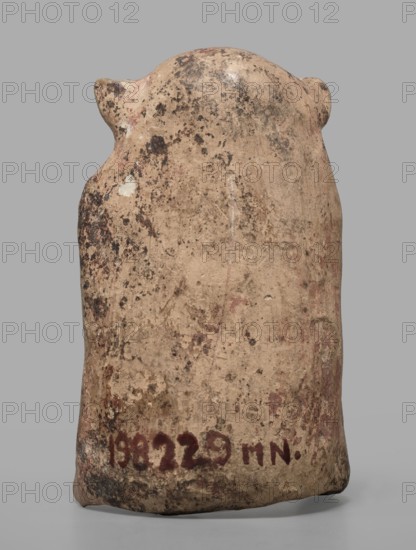 Figurine of a crouching satyr, Greek deities, Satyr myth., terracotta figurine impressed in the mold, 6th–5th century BC formerly dated to the beginning of the 5th century BC, Rhodes; height 7.5 cm, width 4.8 cm, depth 3.8 cm, weight 0.05 kg, A weathered, upright object with a rounded top and small protrusions on either side, showing a textured surface with worn patches and irregular speckling; the visible colors include beige, tan, brown, dark brown, black, pale white, and hints of faded red against a neutral gray background.