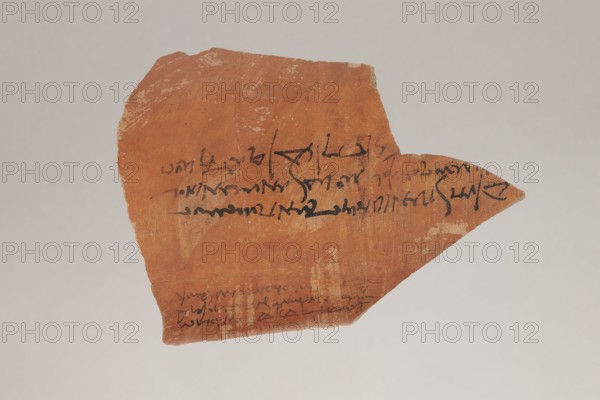 Greek ostraka – two tax receipts, unknown creator/author, taxes, receipts. Fragment of a clay vessel with two tax receipts paid by Panibekis, son of Achillas Rufus, 27/04/161, Edfu Apollonopolis Wielka. Ostraka; height 11.5 cm, width 15.5 cm, depth 0.5 cm, weight 0.136 kg., A broken, irregularly shaped shard with a warm reddish-brown surface sits against a light gray background, showing areas of lighter beige where the surface is worn; a few strokes of dark black markings appear across the shard, and there is a slender pointed extension on one side; the shard's texture looks rough and slightly pitted with subtle variations of red, brown, beige, and tan.