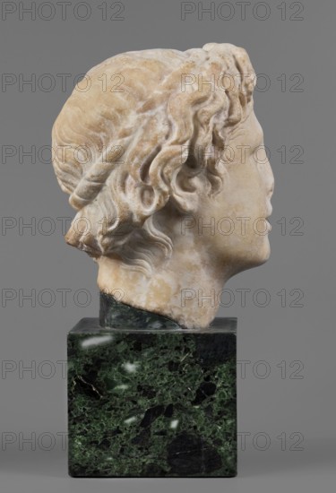 Head of Alexander the Great, unknown Roman workshop. Alexander III the Great King of Macedonia; 356–323 BC. Male portrait, Roman sculpture, Roman copy from a Greek original, head. Description: The head of a young man is clearly turned to the left in a dramatic manner. The head is reflected at the base of the neck. The face is oval; the skeletal structure is not emphasized. The mouth is prominent, with slightly parted lips. The nose is straight, reflected at the tip. The eyes are almond-shaped, deep-set; the eyebrows are expressive, protruding strongly above the eyeball. The forehead is flat, low, and covered with lush locks of hair. Hairstyle: loosely arranged, slightly curled locks; above the forehead, shifted off-axis to the right, a lock of hair radiates outward, slightly raised and clearly different from the other locks. At the back of the head the hair is arranged in wavy locks, with only the lower part freely arranged. Date: 140–160 AD previously dated 150–160 AD. Findspot: Rome ...