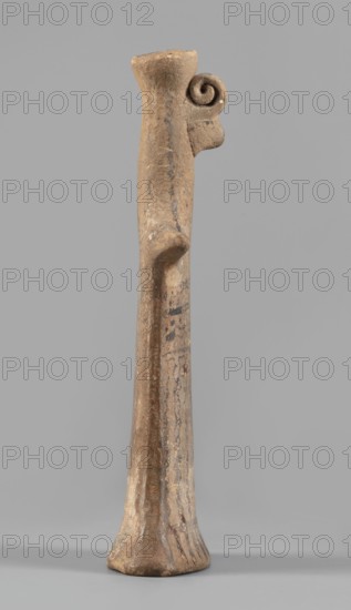Idol, Female figurine, modeled flat, widens towards the bottom to create an oval base, concave underneath. Shoulders have horizontal keel-like projections that merge into a narrow, long, cylindrical neck continuous with the head. Head is covered with a polos; a small curled volute touches the polos and beneath it is a projection like a bird's beak stylizing the face. The volute and projection are glued on. Linear decoration in black paint. Hair strands marked with a wavy line: three falling down the back, two over the shoulders. Traces of transverse lines on the volute. Three lines on each shoulder. The bust has a linear ornament of two wavy lines, two straight lines, and three dotted lines alternating. From the waist, three longitudinal wavy lines run down both sides; between them are two faint straight longitudinal lines curving toward the side. At the widening base is a transverse line from which radiating lines emphasize the oval base. The back is undecorated. Faint traces of brown...