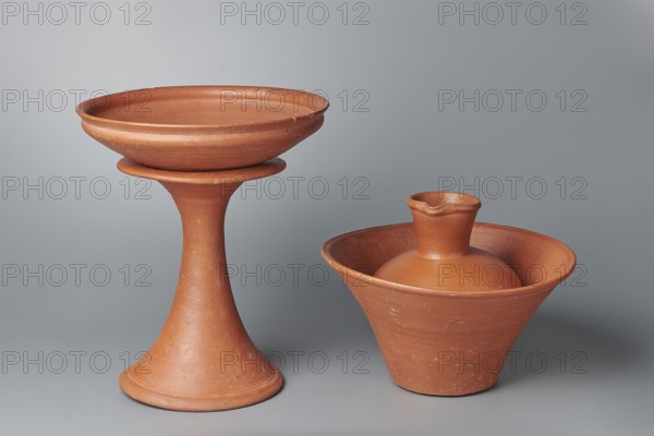 Jug. Medium-sized biconical clay jug with wide, sloping shoulders and a wide neck that is almost cylindrical in its lower section and widens toward the spout; the neck is about one third of the vessel's height. Profiled, irregular spout raised and extended on one side forming a small secondary spout; slightly rounded, almost triangular in cross-section, with a small millimetre-long indentation on the outer profile. Vessel widest at about half its height; bottom almost flat, very slightly rounded. Wheel-made of Nile clay NB1 Vienna System. Outer surface leveled, covered with an engobe and polished; inner surface leveled. Red-brown color. Complete, very well preserved. Old Kingdom, 5th–6th Dynasty, c. 2494–c. 2181 BC; findplace: Edfu. Vessel; height 19.9 cm, rim diameter 8.1 cm, bottom diameter 9.5 cm, body diameter 16.7 cm, weight 1.1 kg. Analogies: T. Rzeuska, Saqqara II, pp.150–151, pl.54, cat.210; G. Brunton, Qau and Badari, pl. XLII, 661 V; an analogous vessel is in the Louvre., A p...