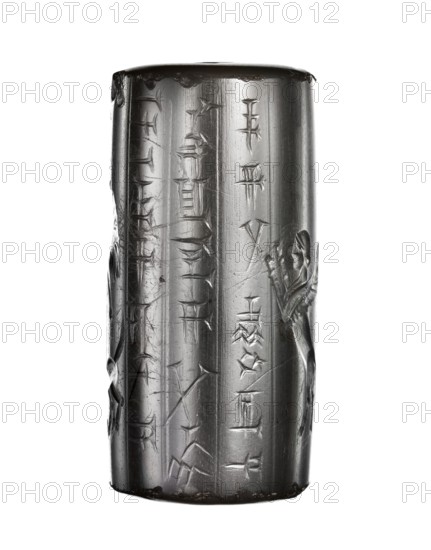 Cylinder seal, unknown Neo-Babylonian workshop; later modification by an unknown Achaemenid workshop addition of a palm tree, a dog, and a fantasy creature. Iconography: date palms, altar, priest/worshipper standing in prayer before an altar with astral symbols — a star symbol of Ishtar and a crescent symbol of Sin. Includes a three-column cuneiform inscription containing a standard Neo-Babylonian prayer: God Nabu, protect my life, grant me health. Seal of Nabu-ahu-iddina, son of Nabu-mukin-apli. Later additions: a date palm with a dog behind the priest and a fantastic creature — winged bull with a human head — between the altar and the inscription, standing on hind legs with raised forelegs gesture of adoration. Added elements have analogies in Achaemenid glyptics and are likely dated to the 5th century BC. Date: 6th century BC, Neo-Babylonian period palm tree with dog and fantastic creature added in the Achaemenid period, 539–323 BC. Place of production/finding: Babylonia / Southern ...