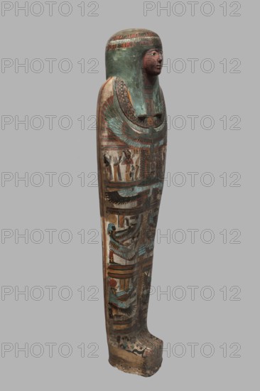 Mummy of Panepi in a cartonnage, doorkeeper of the temple of Amun Panepi, Panepi ca. 945–715 BC. Richly decorated cartonnage. The deceased's wig and mask are sculpturally detailed. On the chest is a necklace with a plant and geometric ornament. Below is a centrally located i3-w fetish mounted on a djed sign, behind which an inscription begins. On the sides of the fetish are winged goddesses Isis and Nephthys and the Horuses of Edfu. At the base of the fetish are depictions of Upuaut. Above the fetish is a depiction of a ram-headed bird with outstretched wings Amun-Ra and Wadjet cobra, Osiris, and three Sons of Horus. The deceased's hands are not modeled. c. 825–715 BC; Third Intermediate Period, late 22nd–23rd Dynasty, Western Thebes. Sarcophagus, mummy, cartonnage; height 170 cm, width 40 cm, depth 29 cm, weight 37.5 kg., A tall, narrow painted wooden figure shaped like a wrapped body with a stylized human head wearing a long headdress, showing a painted face in brown and reddish tone...