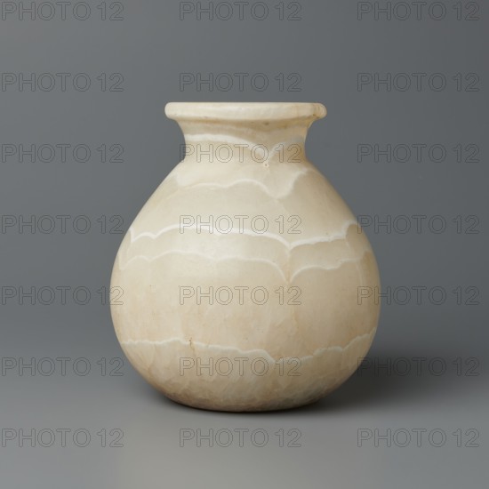 Vessel, Globular vessel with a short, wide neck and a large, upturned spout, with a flattened bottom. Stone. ca. 1550–1069 BC; New Kingdom, Egypt. Vessel; height 14.8 cm, width 13.4 cm, weight 1.32 kg., A rounded pale beige vase with a short neck and flared rim sits centered against a smooth gray background; the vase surface shows layered, scalloped banding in slightly lighter and slightly darker beige tones creating a cloudlike pattern, with subtle natural veining and a soft matte texture.