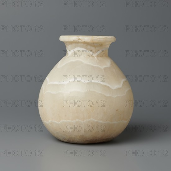 Vessel, Globular vessel with a short, wide neck and a large, upturned spout, with a flattened bottom; stone; ca. 1550–1069 BC, New Kingdom, Egypt; vessel; height 14.8 cm, width 13.4 cm, weight 1.32 kg., A rounded vase with a short flared neck sits against a solid backdrop, showing a smooth, polished surface with layered banding that forms scalloped patterns; the colors visible include cream, beige, off-white, and pale tan, with subtle variations and slight darker speckles, and the background and surface beneath the vase appear in shades of gray.