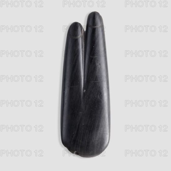 Amulet in the shape of two fingers index and middle with marked nails and skin folds; the back of the amulet is smooth and undecorated. Two-finger amulet, 664–525 BC; Late Period, 26th Dynasty, Egypt. Material: amulet; height 8.5 cm. Maker/, A smooth, elongated dark object with a polished black surface showing subtle lighter streaks and scuffs rests against a pale gray background, the top split into two rounded prongs with shallow curved grooves near their tips and the lower end rounded with a small nick, overall displaying shades of black, dark gray, and faint lighter gray highlights.