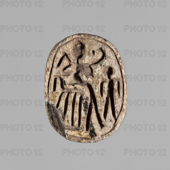 Scarab with a silhouette of a ruler on a throne. The scarab has on its base a representation of a royal figure sitting on a throne, with a scepter and a whip in its hands, possibly Osiris, and a second, smaller standing figure. ca. 1550–1295 BCE; New Kingdom, 18th Dynasty, Egypt. Scarab amulet; height 3.1 cm, width 2.2 cm., An oval carved object with a weathered, beige surface showing darker brown and black areas, depicting a raised relief of two stylized human-like figures surrounded by carved lines and recessed shapes; the background is a uniform light gray.