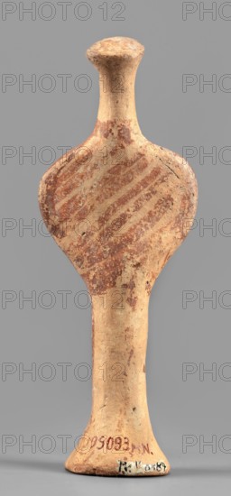 Female idol, unknown Mycenaean workshop. Votive female figurine in the shape of the letter phi: legs form a cylindrical base widening downward skirt?, arms and torso enclosed in a circle, breasts schematically marked, long cylindrical neck, flat head. Folds of garments, facial features, and eyes simplified using brown paint or varnish; painted surface worn in places. Dated 1400–1200 BC previously 1600–1100 BC. Provenance: Mycenae, Greece. Figurine votive offering. Height 12.7 cm, width 4.6 cm, depth 2.8 cm, weight 0.05 kg., An elongated, hourglass-shaped ceramic object with a rounded top and flared base, showing a textured, weathered surface; the upper bulb has diagonal banded markings in reddish-brown against a beige-tan background, and the narrow midsection and base are mostly beige-tan with small areas of reddish-brown spotting and wear; the object sits against a plain gray backdrop.