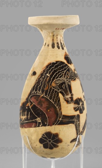 Orientalizing alabastron with depictions of horses, circa 620–590 BC, Corinth. Small aryballos alabastron; vessel height 10.0 cm with supplement, original preserved height 8.4 cm, width 4.7 cm, weight 0.066 kg. Decoration: remnants of a radial ornament under the rim; paired horse prototypes positioned opposite each other, ending in bird-like tails, occupying the vessel’s full height; very precise engraved modeling, red retouches, small filling ornaments rosettes; radial ornament on the underside. Technology: smooth surface, yellow clay. Notes: reconstructed rim, visible chips and impurities. Clay color: 2.5 Y 7/4 pale yellow; varnish color: 10 YR 2/1 black; red color: 7.5 R 4/4 red., A small egg-shaped ceramic vessel with a flared rim stands on a clear support; its surface shows a cream background with painted black and dark reddish-brown decorations, including a large stylized animal figure with a curled mane and elongated snout rendered in black with fine incised lines, surrounded by...