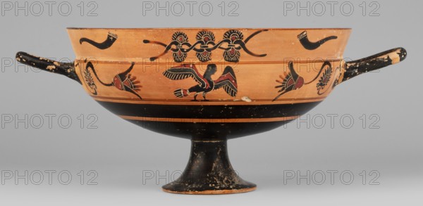 Kylix with a depiction of a mermaid and sphinxes, Griffin-Bird Painter; fantasy creatures iconography: sphinxes, sirens; Greek pottery, 570–550 BC previous dating ca. 545 BC; Attica; vessel kylix; weight 0.314 kg., A shallow, two-handled bowl on a stemmed foot with a rounded body and flared rim, decorated with painted motifs and showing areas of wear; the surface colors include terracotta orange, black, and accents of dark red and off-white, with black handles and a predominantly black lower body and foot, orange upper body and rim, and red details within some painted elements.
